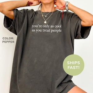 a woman wearing a t - shirt that says you're only as cool as
