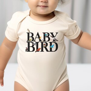 a baby wearing a bodysuit that says baby bird