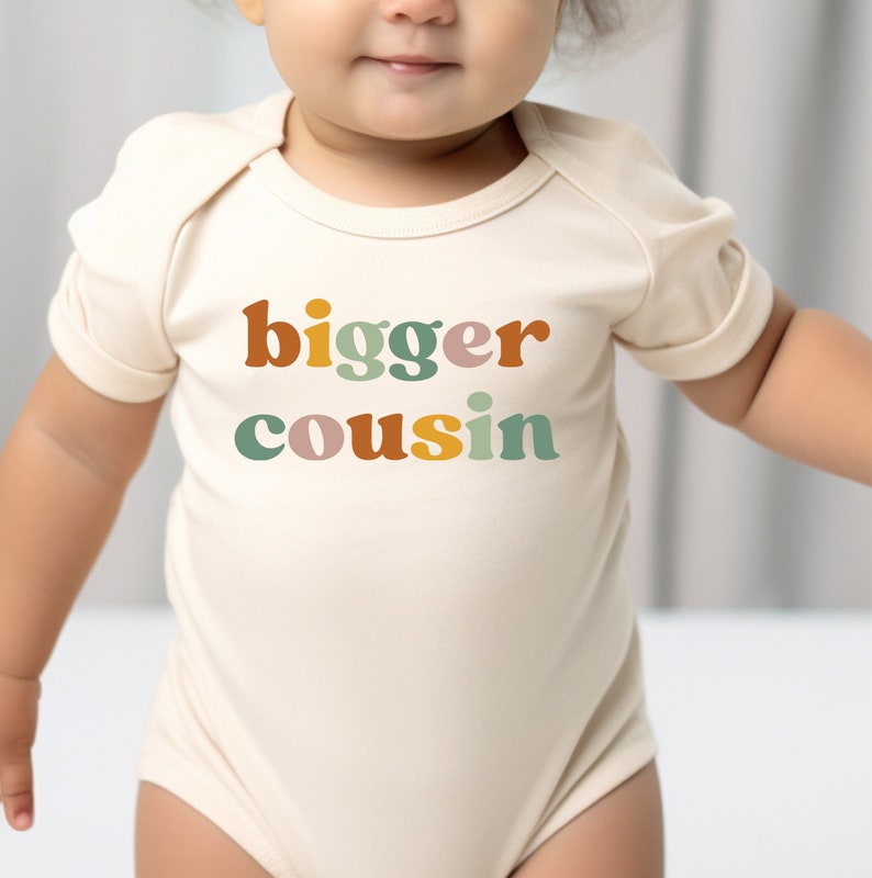 a baby wearing a bodysuit that says bigger coughin