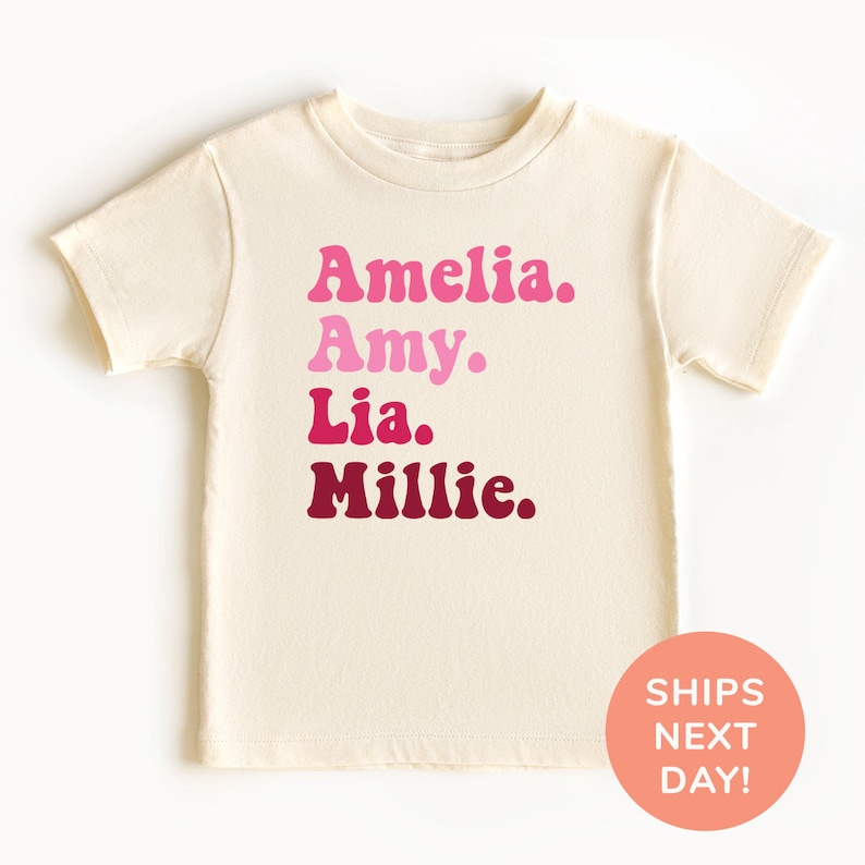 a white t - shirt with pink lettering on it