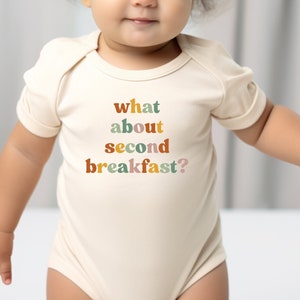 a baby wearing a bodysuit that says what about second breakfast?