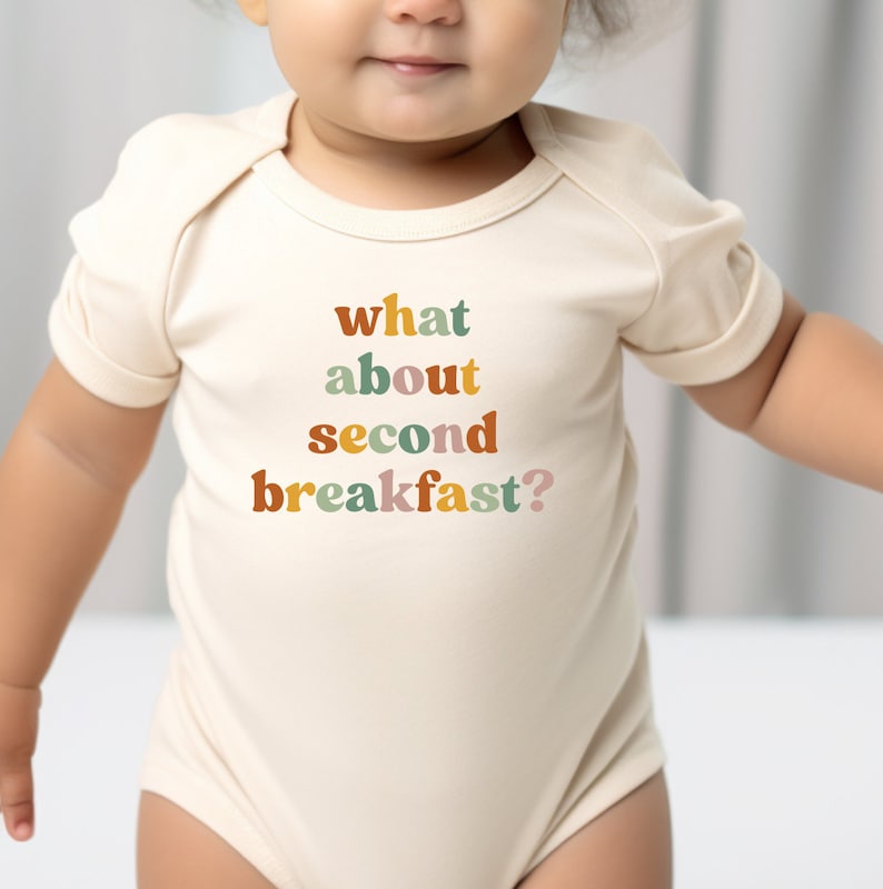 a baby wearing a bodysuit that says what about second breakfast?