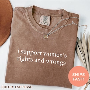 May include: A brown t-shirt with the text "i support women's rights and wrongs" printed in white. The shirt is made of a soft, comfortable material and has a relaxed fit.