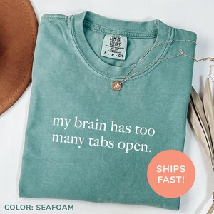 a t - shirt that says, my brain has too many tabs open