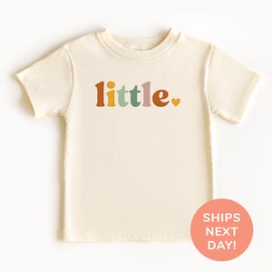a white shirt with the words little on it