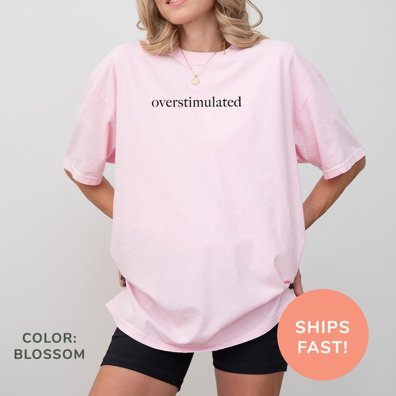 a woman wearing a pink overstuffed shirt with the words overstuffed on