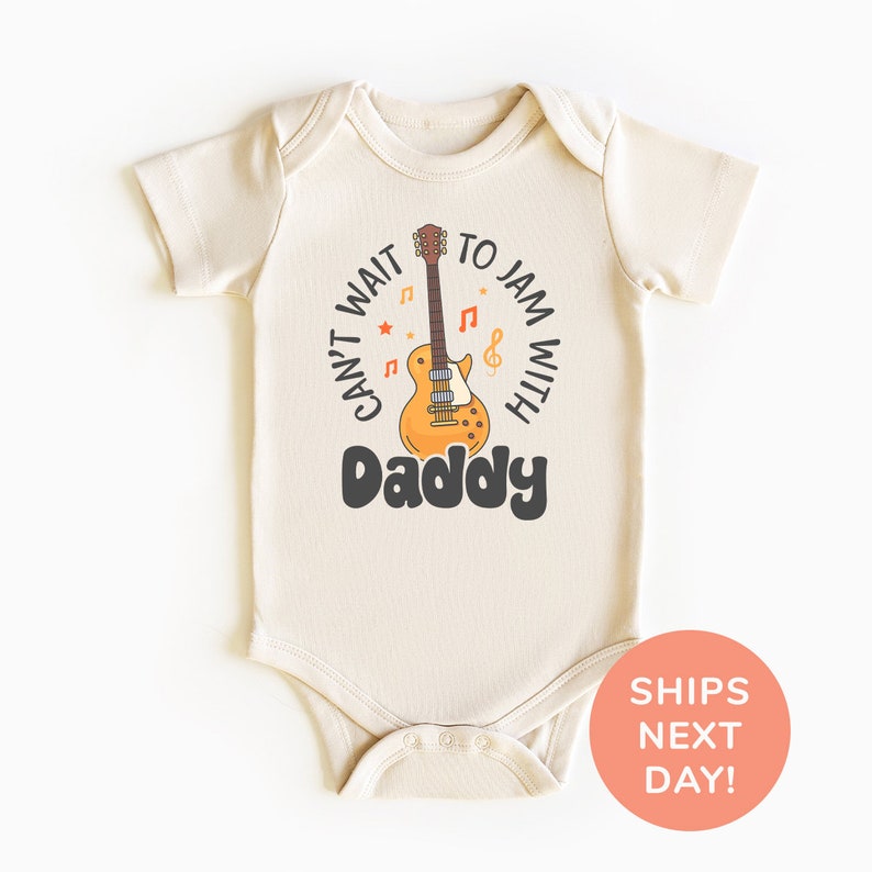 a baby bodysuit with a guitar on it