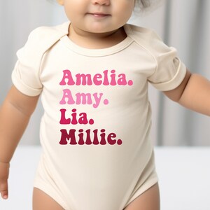 a baby girl wearing a bodysuit that says, amella, amy,