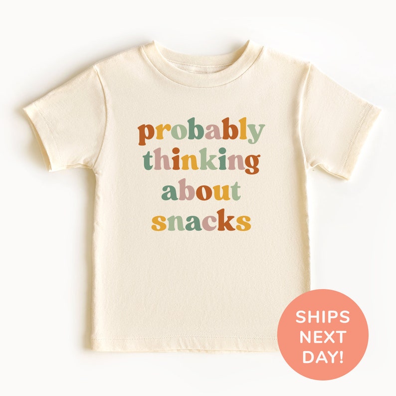 a t - shirt that says probably thinking about snacks