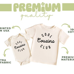 May include: Two white cotton shirts with the text "Cool Cousins Club" printed in black. The smaller shirt is a bodysuit and the larger shirt is a t-shirt.