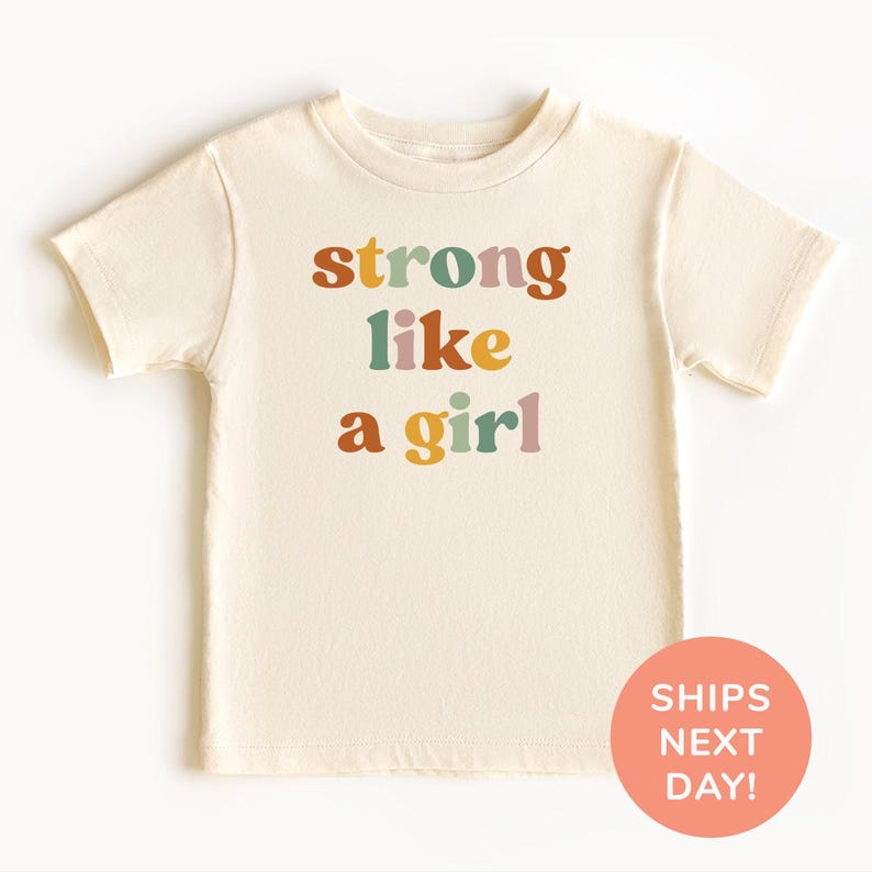 a t - shirt with the words strong like a girl printed on it