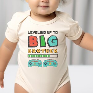 a baby wearing a bodysuit that says, leveling up to big brother