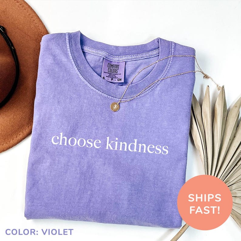 a t - shirt that says choose kindness and a hat next to it