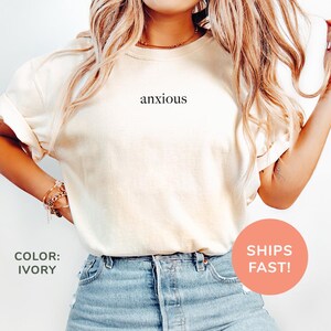 a woman wearing a t - shirt that says anxious