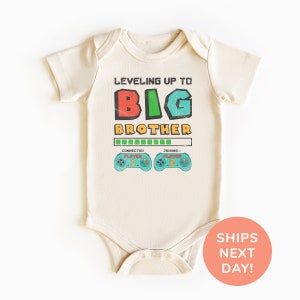 a baby bodysuit with the words, leveling up to big brother on it