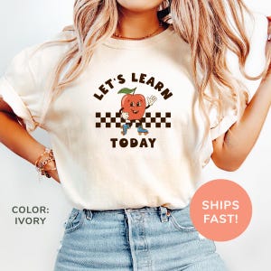 a woman wearing a t - shirt that says let's learn today