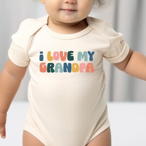 a baby wearing a bodysuit that says i love my grandpaa
