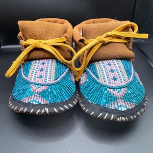 May include: A rustic wooden sign with the text "Welcome to our home" in a handwritten style. The sign features a distressed finish and a simple, inviting design, perfect for a front porch or entryway.