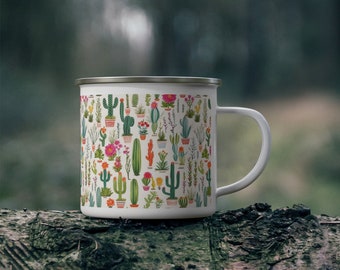 May include: White enamel mug featuring a colorful pattern of various cacti and succulents in pots. The mug has a silver rim and a white handle. The design includes green, orange, pink, and yellow cacti on a cream background.