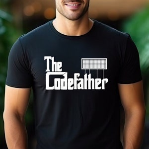 May include: A black t-shirt with a white graphic that says "The Codefather" with a stylized circuit board above the text.
