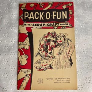 May include: Vintage "Pack-O-Fun" magazine cover. The cover is red and black with the title "PACK-O-FUN" in large black letters. The magazine is a "SCRAP-CRAFT MAGAZINE". The cover art features a doll holding a book and a Christmas tree.