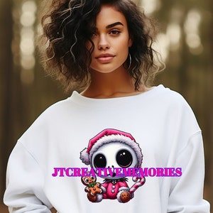 May include: White sweatshirt with a pink and white cartoon skeleton wearing a Santa hat and holding a gingerbread man and a candy cane. The text "JT CREATIVE MEMORIES" is printed on the sweatshirt.