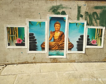 May include: Five framed canvas prints depicting a serene scene with a meditating Buddha figure in the center. The Buddha is depicted in a golden hue, sitting on a platform with a blue background. The other four frames feature a blue background with stacked stones and bamboo plants.