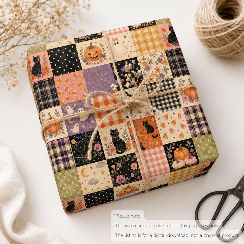 May include: A square gift box wrapped in paper with a patchwork design featuring Halloween motifs including black cats, pumpkins, ghosts, candy corn, spider webs, and floral patterns in orange, black, purple, and cream, tied with natural jute twine.