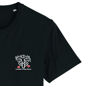 May include: Black t-shirt featuring a white graphic of a person with arms raised and three red hearts. The text "CLOWNTOWN BY GRACE DORANT" is printed below the graphic.
