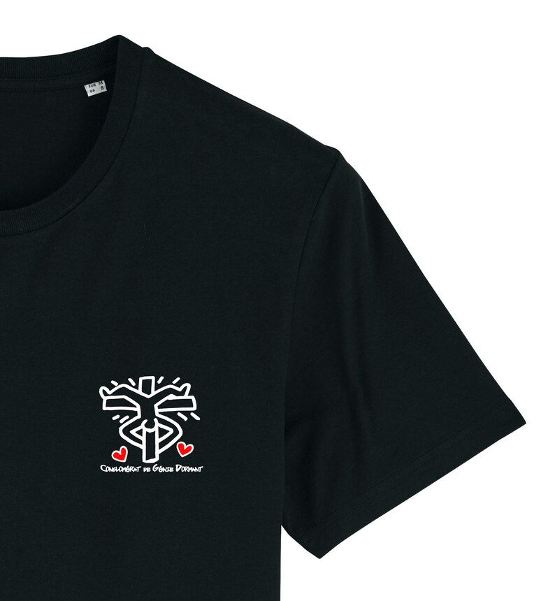 May include: Black t-shirt featuring a white graphic of a person with arms raised and three red hearts. The text "CLOWNTOWN BY GRACE DORANT" is printed below the graphic.