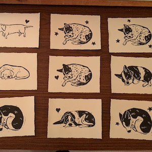 May include: A set of three ceramic mugs with a speckled, matte finish. The mugs are in shades of cream, light gray, and dark gray. Each mug has a simple, minimalist design and a rounded handle. The mugs are suitable for coffee, tea, or other beverages.