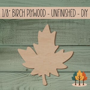 May include: Unfinished 1/8 inch thick birch plywood maple leaf cutout. The leaf is on a green wooden background.