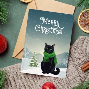 Chat noir de Noël avec cadeau écharpe, cadeau de Noël, carte de voeux de Noël