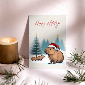 Leuke wintercapibara-briefkaart | Unieke, met de hand geïllustreerde kerstwenskaart voor seizoensgejuich | Kerstcapibara ansichtkaart cadeau