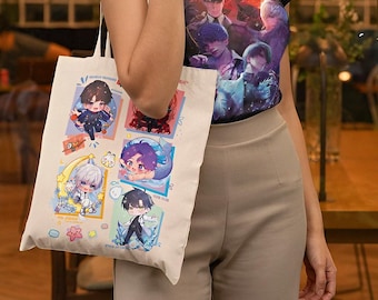 May include: A white canvas tote bag with a colourful design featuring cartoon characters. The bag has a blue, pink and yellow colour scheme and features characters with different expressions. The bag has a long strap and is perfect for carrying everyday essentials.