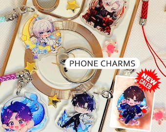 May include: A collection of phone charms featuring anime-style characters. The charms are made of clear acrylic and feature colorful designs. The charms are attached to phone cases with a variety of different types of strings and chains. The text "PHONE CHARMS" is visible in the image.