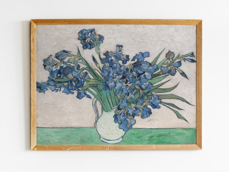 May include: A framed painting depicting a bunch of blue irises in a white vase. The flowers are arranged in a casual, natural way, and the background is a light grey.