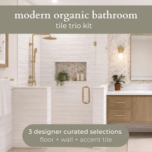 May include: A modern organic bathroom tile trio kit featuring three designer curated selections for floor, wall, and accent tile. The bathroom includes white horizontal wall tiles, a shower niche, brass fixtures, a wooden vanity, and a mirror.