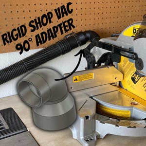 May include: A silver and yellow miter saw with a black hose and a gray 90-degree adapter. The text "RIGID SHOP VAC 90° ADAPTER" is in the upper left corner.
