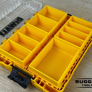 May include: Yellow plastic storage box with multiple compartments. The box is labeled "DEWALT" and "RUGGED TOOLS".