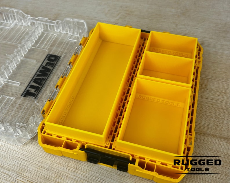 May include: A yellow plastic tool box with a clear lid. The box has a removable tray with multiple compartments. The tray is labeled "Rugged Tools".