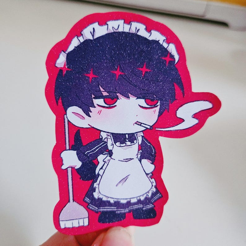 May include: A sticker featuring a cartoon character in a maid outfit, smoking a cigarette. The character has dark hair, red eyes, and a red star design. The sticker has a red border and a white apron.