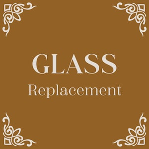 May include: A brown background with a white ornate border. The text "GLASS Replacement" is centred on the background.