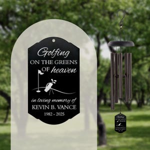 May include: Black metal wind chime with a rectangular plaque that reads "Golfing on the greens of heaven in loving memory of Kevin B. Vance 1982-2025".