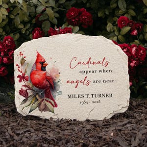 May include: A stone memorial plaque featuring a watercolour illustration of a cardinal and the text "Cardinals appear when angels are near." The plaque also includes the name "MILES T. TURNER" and the years "1954 - 2025."