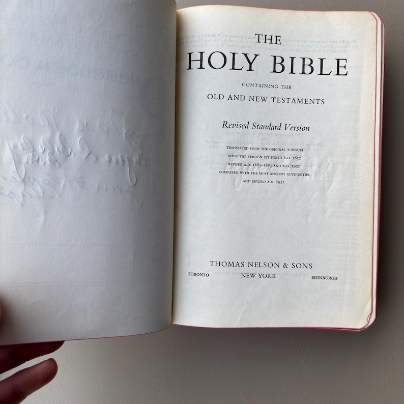May include: The title page of The Holy Bible, Revised Standard Version, containing the Old and New Testaments. The text includes publication details for Thomas Nelson & Sons in Toronto, New York, and Edinburgh, with a 1952 revision date.