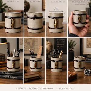 May include: A cylindrical desk organiser made of light-coloured material, featuring two dark brown leather cords wrapped around the exterior and secured by a central brass-toned metal bead. It measures 5 cm in diameter and 6 cm in height.