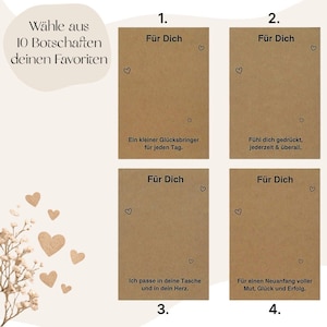 Puede incluir: Cuatro tarjetas de papel kraft con ilustraciones de corazones y texto en alem&aacute;n. Las tarjetas est&aacute;n etiquetadas como "F&uuml;r Dich" y presentan mensajes como "Un peque&ntilde;o amuleto de la suerte para cada d&iacute;a."