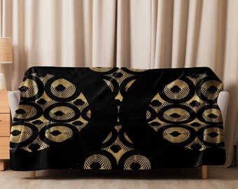 May include: Black and gold throw blanket with a geometric pattern of overlapping circles. The circles have a sunburst design.
