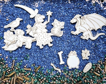 May include: A witch, cat, dragon, frog, and cauldron cutouts on a blue background with gold and green sprinkles.